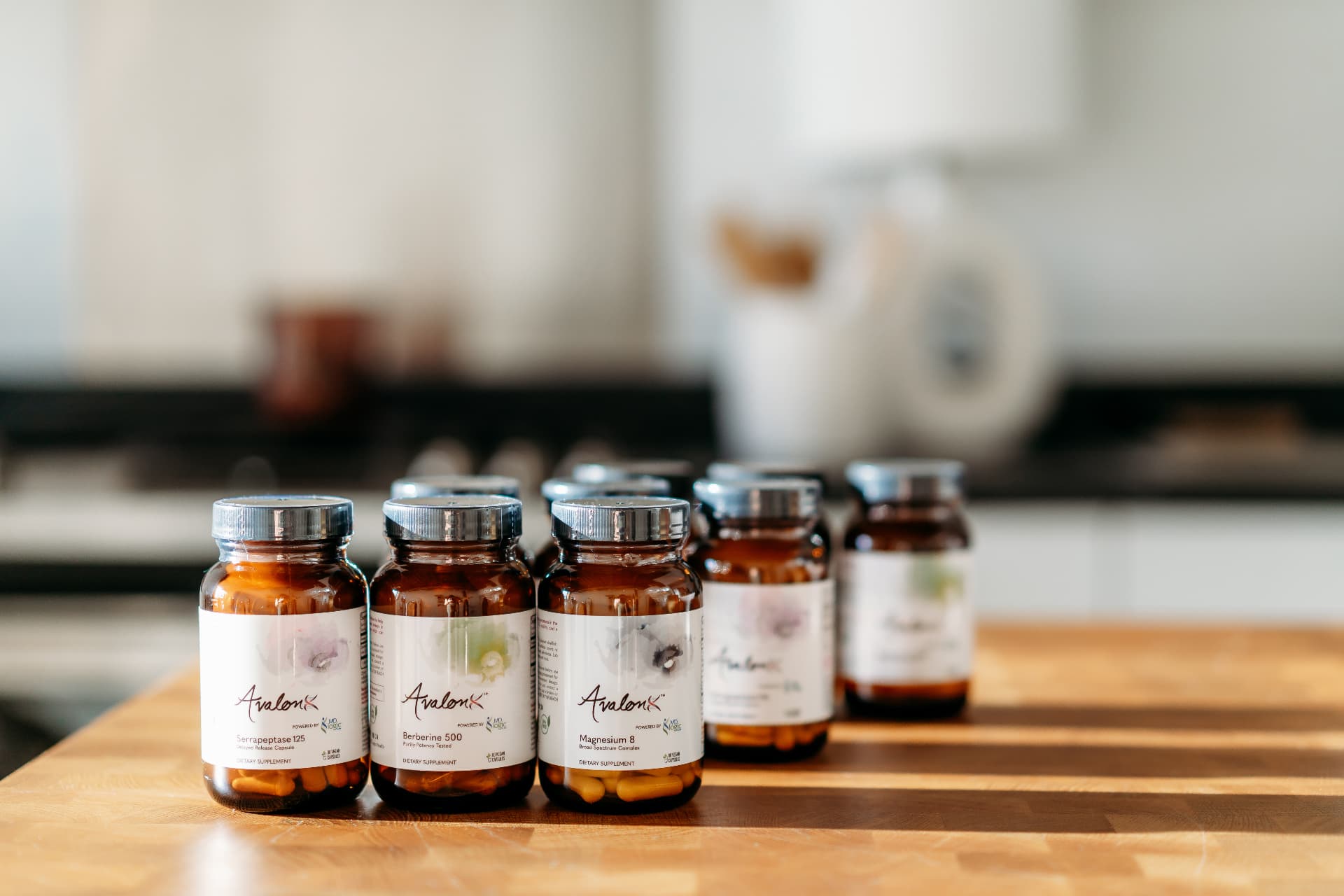 The full AvalonX supplement collection on a wooden counter
