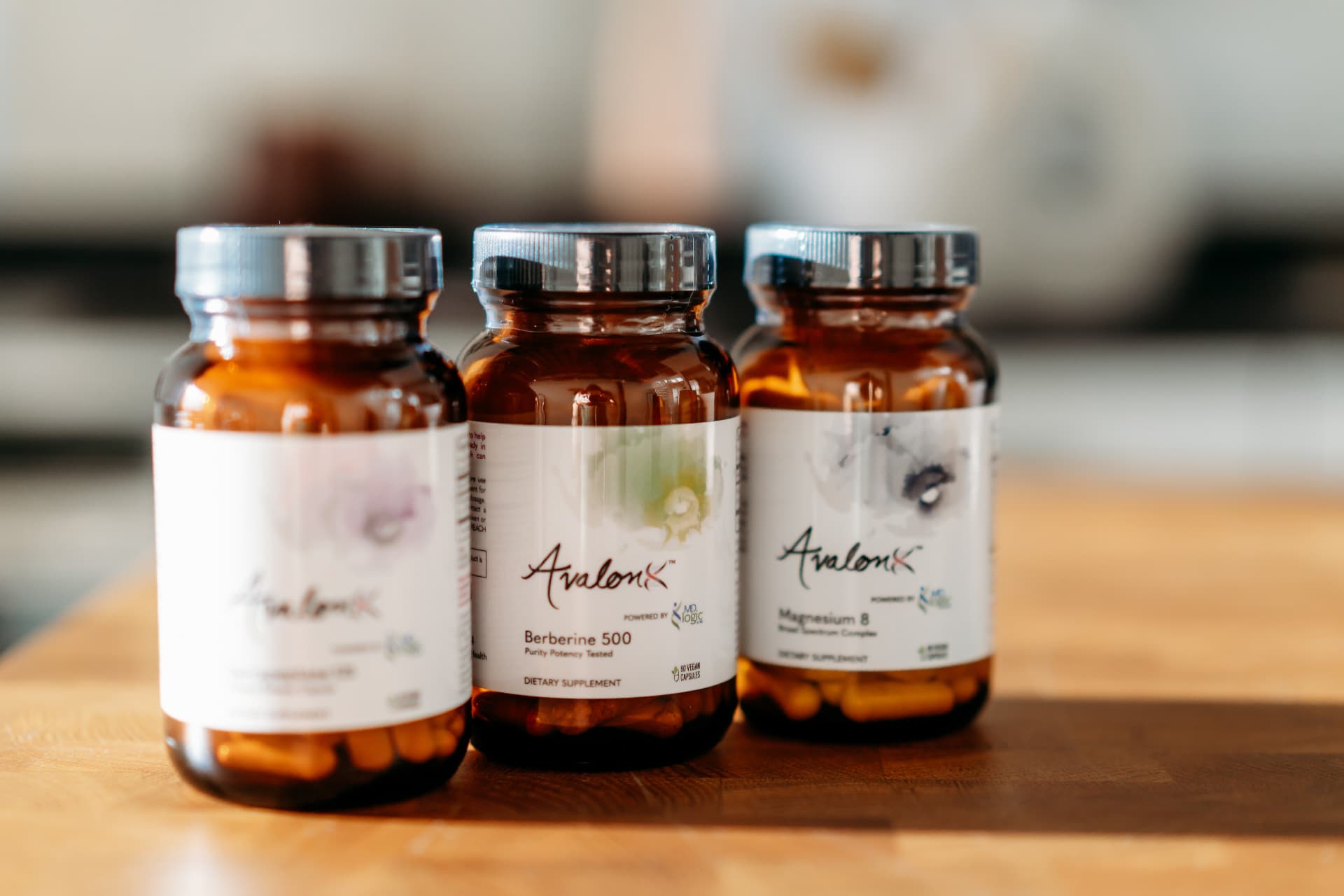 AvalonX supplement bottles on a wooden table